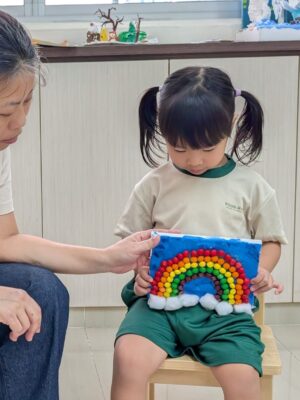 Child with teacher with her work